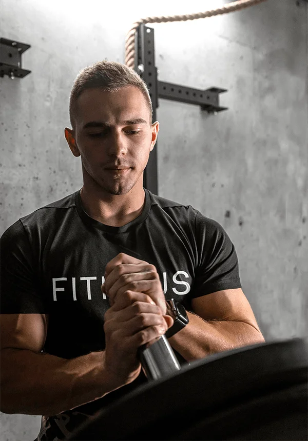 FITHAUS coach loading a barbell