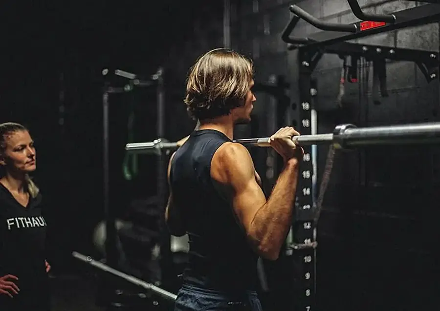 Coach performing a weighted pull