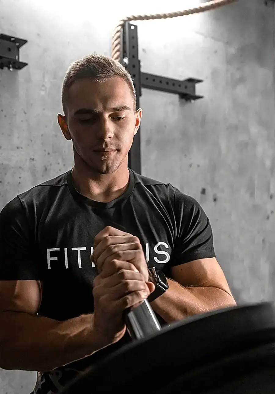 FITHAUS coach loading a barbell