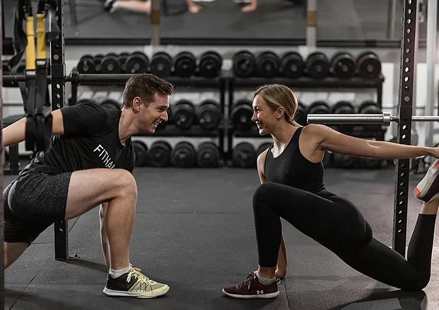 Coach guiding a client through a lunge